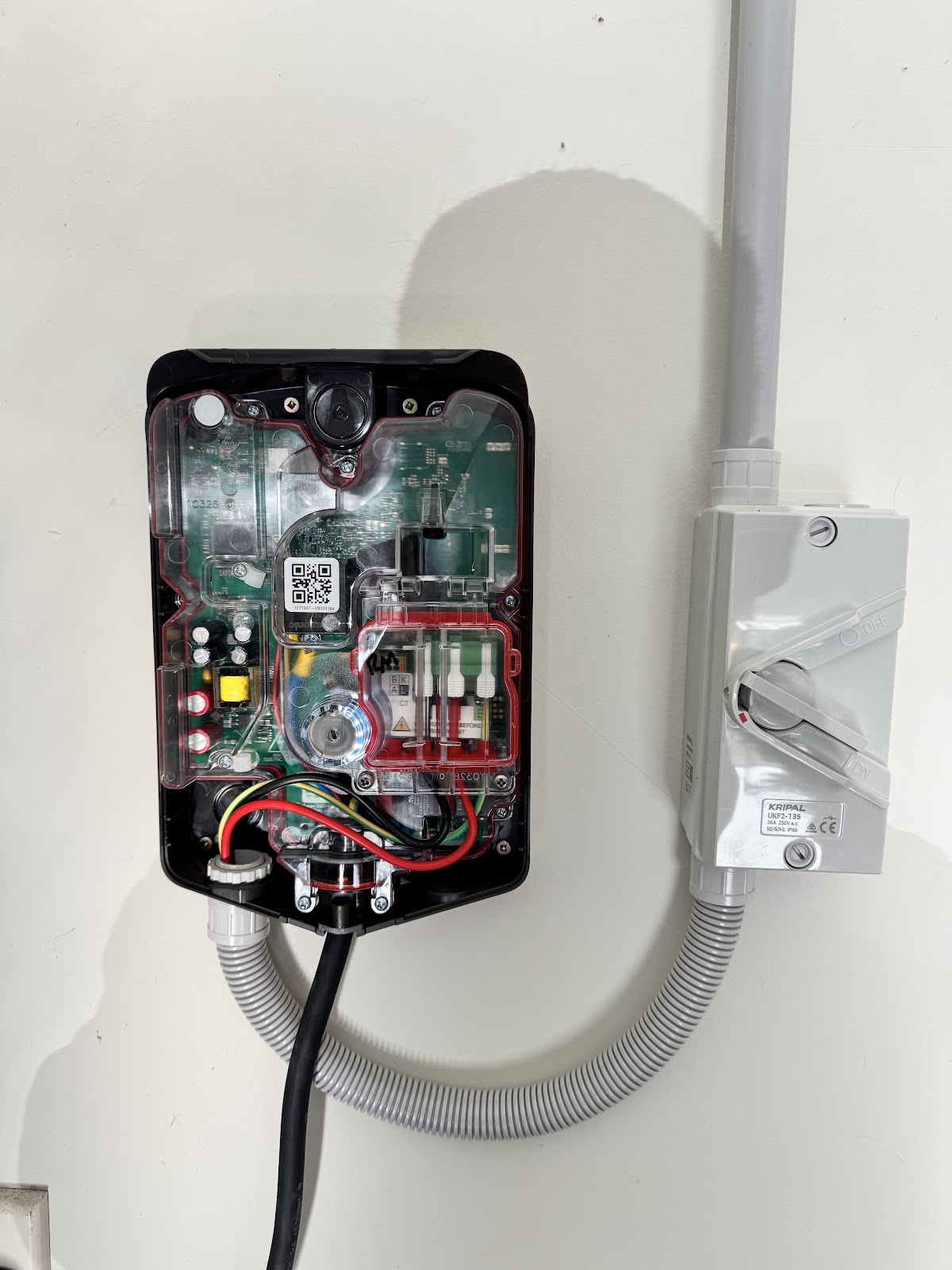 EV charger internals wired up beside an isolator switch