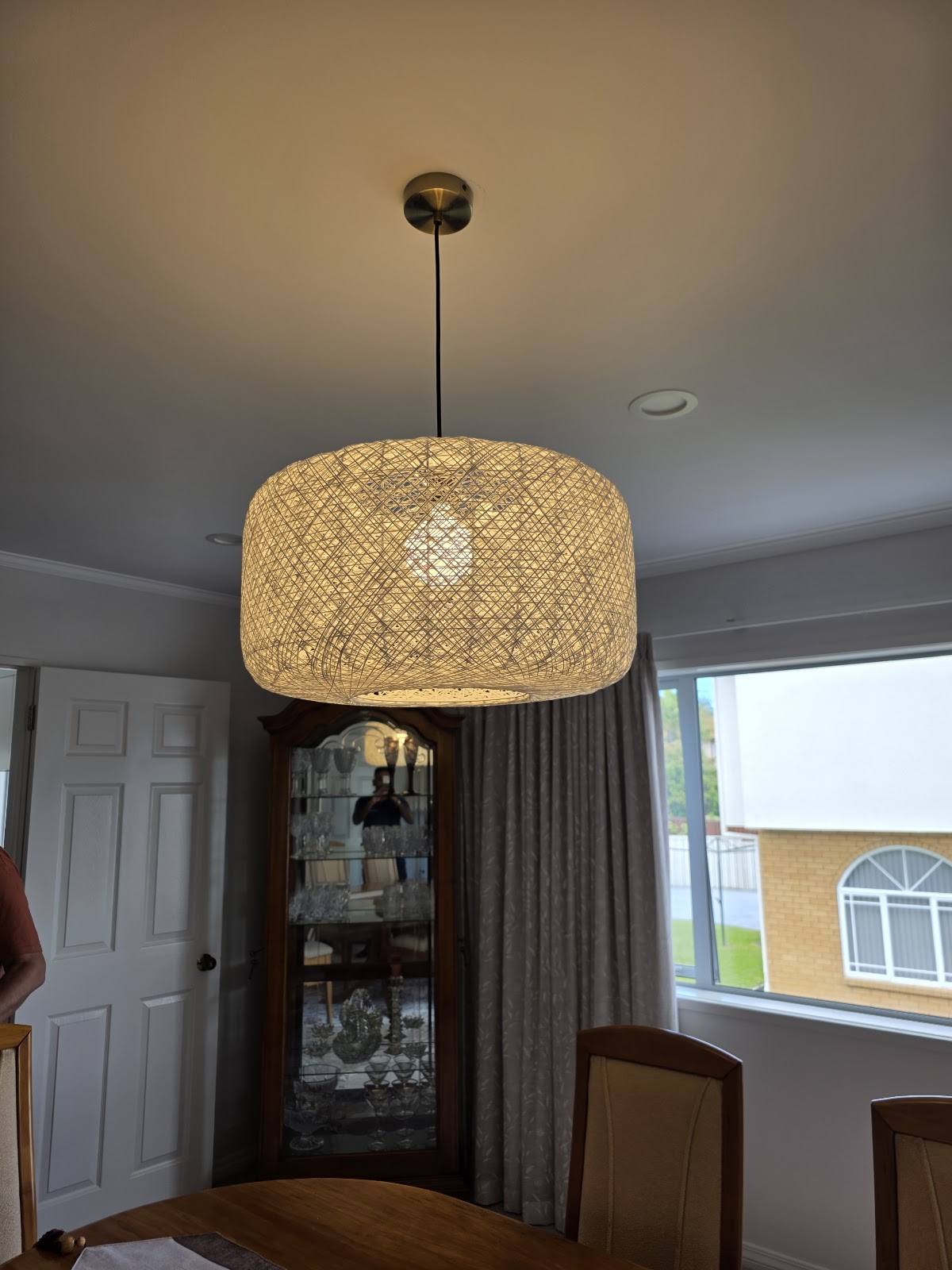 Rattan pendant light installed in a dining room